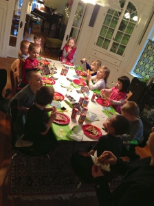 All of them sitting down to pizza -pre-cake.