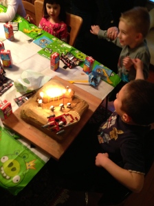 buddy by his side, ready to blow out the candles.